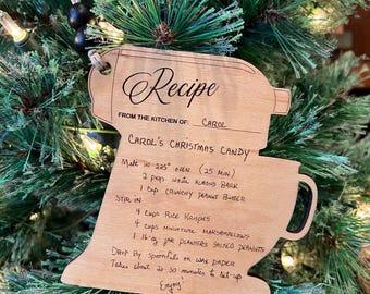 May include: Wooden Christmas ornament shaped like a stand mixer with a recipe for Carol's Christmas Candy written on it. The recipe includes ingredients like Rice Krispies, marshmallows, and peanut butter.