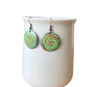 Celadon green enamel earrings with red pattern