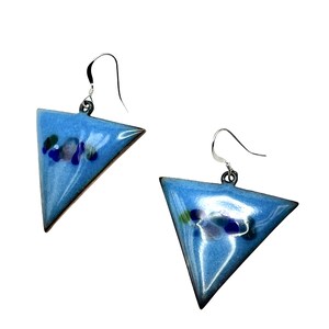 May include: A pair of triangular earrings with a light blue enamel finish. The earrings have a silver hook and are decorated with small, colourful glass pieces. The edges are outlined in a dark brown colour.