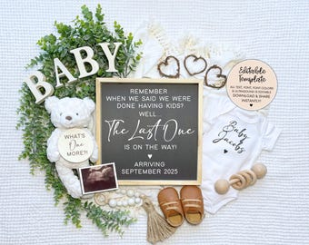 May include: A baby announcement featuring a chalkboard sign that reads "The Last One is on the way! Arriving September 2025". The sign is surrounded by a white teddy bear, a white onesie with the text "Baby Jacob's", a wooden circle with the text "What's One More?!", a wooden rattle, and a pair of brown baby shoes.