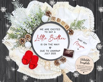 May include: A white and red baby announcement sign with a winter theme. The sign says "We are excited to say a Little Brother is on the way! Due to unwrap July 2025". There is a white onesie with the text "Baby Boy Mason" and a small ultrasound image.