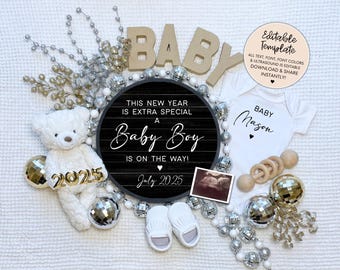 May include: A black and white sign with the text "This new year is extra special a Baby Boy is on the way! July 2025". The sign is surrounded by silver and gold ornaments, a white teddy bear, and a white onesie with the text "Baby Mason".