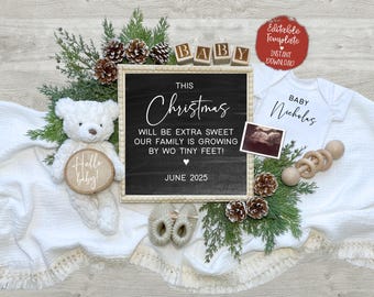 May include: A chalkboard sign with the text "This Christmas will be extra sweet our family is growing by two tiny feet! June 2025". A white baby onesie with the text "Baby Nicholas" is next to the sign. A white teddy bear with a sign that says "Hello baby!" is in the foreground. The sign is surrounded by greenery and a white blanket.