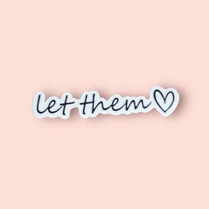 May include: White sticker with black lettering that reads "Let Them" with a small heart symbol.