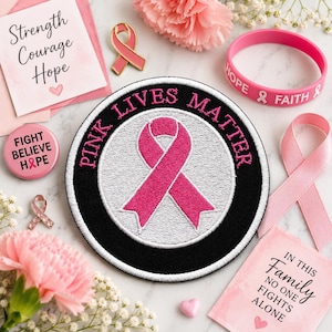 May include: A circular embroidered patch featuring a pink awareness ribbon on a white background with the black text PINK LIVES MATTER. The patch is surrounded by a pink silicone bracelet, a pink ribbon pin, a round button, and two cards with text.