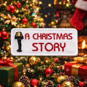 May include: A white ceramic mug with a black handle and the text "But First, Coffee" in a bold, black font. The mug is set against a blurred background, suggesting a cozy setting.