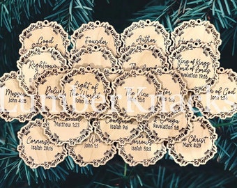 May include: A collection of 16 wooden ornaments with a floral design and a bible verse on each. The ornaments are light brown and have a rustic look. The verses include "Good", "Righteous", "Founder", "Light of the World", "Messiah", "Delus", "Author", "The Vine", "King of Kings", "Lord of Lords", "Son of God", "Emmanuel", "Cornerstone", "Word", "Sorrow", "Alpha and Omega", and "Christ".