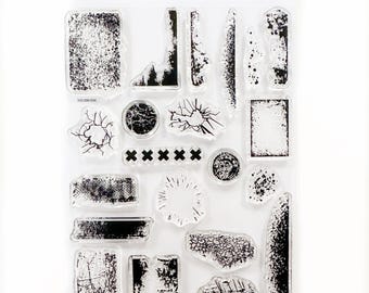 May include: A clear sheet of transparent stamps with black ink designs. The stamps feature various textures, including cracked, distressed, and grunge patterns. The sheet is labeled "Crafty By Toni" and "Grunge Textures 1".