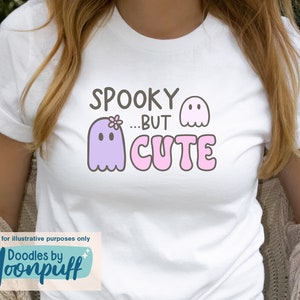 May include: White t-shirt with a purple ghost with a flower on its head and the text "Spooky...But Cute" in pink letters.