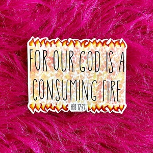 May include: A rectangular sticker with a white border and a flame-patterned edge. The center features a yellow and orange speckled background with the black text FOR OUR GOD IS A CONSUMING FIRE and the smaller text HEB 12:29 below it.