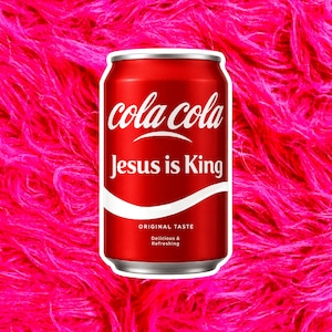 May include: A red aluminum soda can featuring the white text cola cola and Jesus is King. Below the text, the can displays the words Original Taste, Delicious & Refreshing, and a white curved line graphic on the lower portion of the red surface.