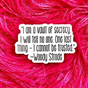 May include: A white sticker with a black quote on a pink fuzzy background. The quote reads "I am a vault of secrecy. I will tell no one. One last thing - I cannot be trusted."  ~Woody Strode