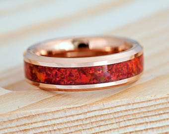 May include: A rose gold tungsten carbide ring with a red and brown inlay. The ring has a beveled edge and a polished finish.