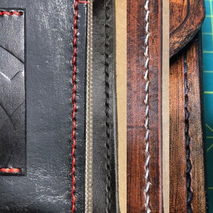 May include: Close-up of leather goods showcasing different thread colors. The image displays black leather with red stitching, black leather with black stitching, brown leather with white stitching, and brown leather with black stitching. The text "Thread Color" is visible.