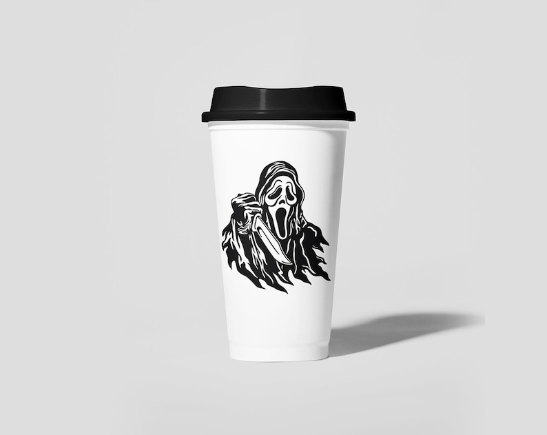 May include: A white to-go coffee cup with a black lid. The cup has a black and white graphic of a ghost wearing a mask and holding a knife.