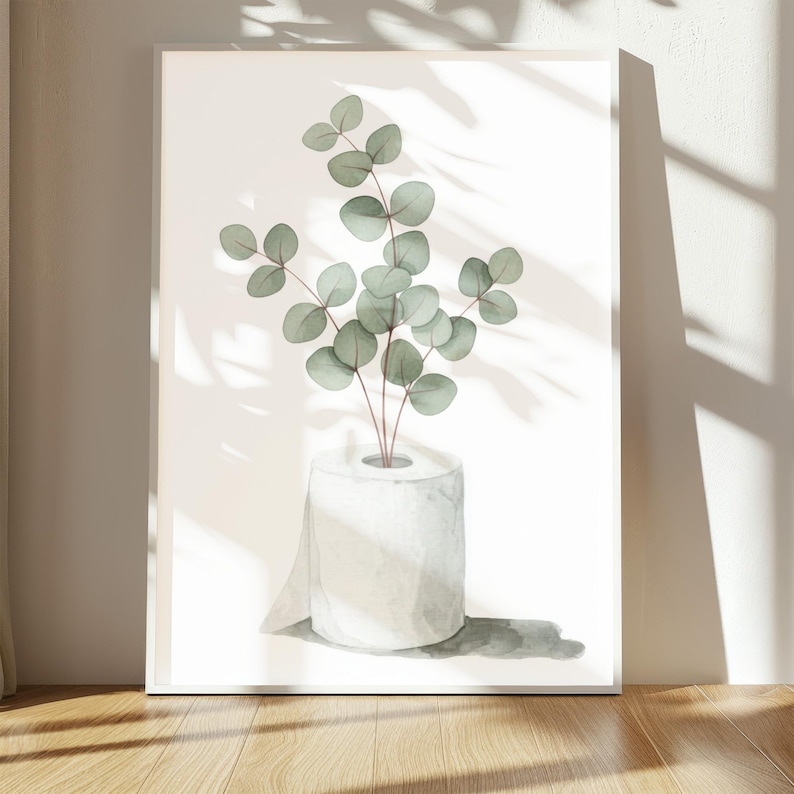 Op de afbeelding: Aquarel kunstafdruk met een rol wit toiletpapier met eucalyptus takken. Het kunstwerk heeft een minimalistische stijl met zachte groene en grijze tinten. De afdruk wordt weergegeven op een witte achtergrond.