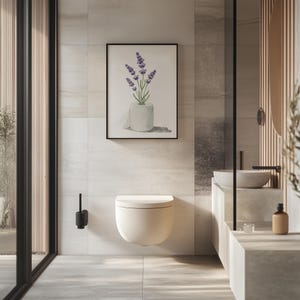 May include: A modern bathroom featuring a wall-mounted toilet, a framed watercolor print of lavender in a toilet paper roll, and a minimalist sink area. The color palette is neutral with shades of white, gray, and beige, creating a serene atmosphere.
