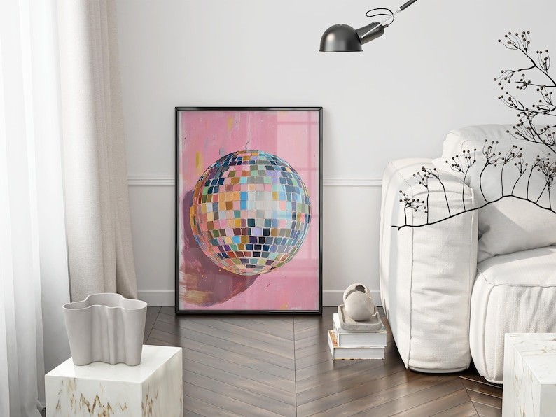 a living room with a large, colorful disco ball as the focal point. The room has a white couch, a lamp, and a plant, creating a modern and stylish atmosphere.