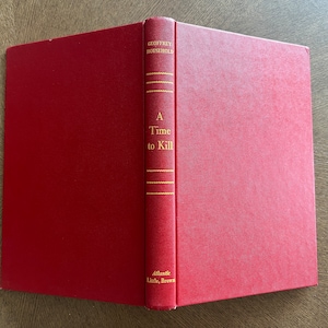 May include: A red hardcover book titled "A Time to Kill" by Geoffrey Household. The book is published by Atlantic Little, Brown.