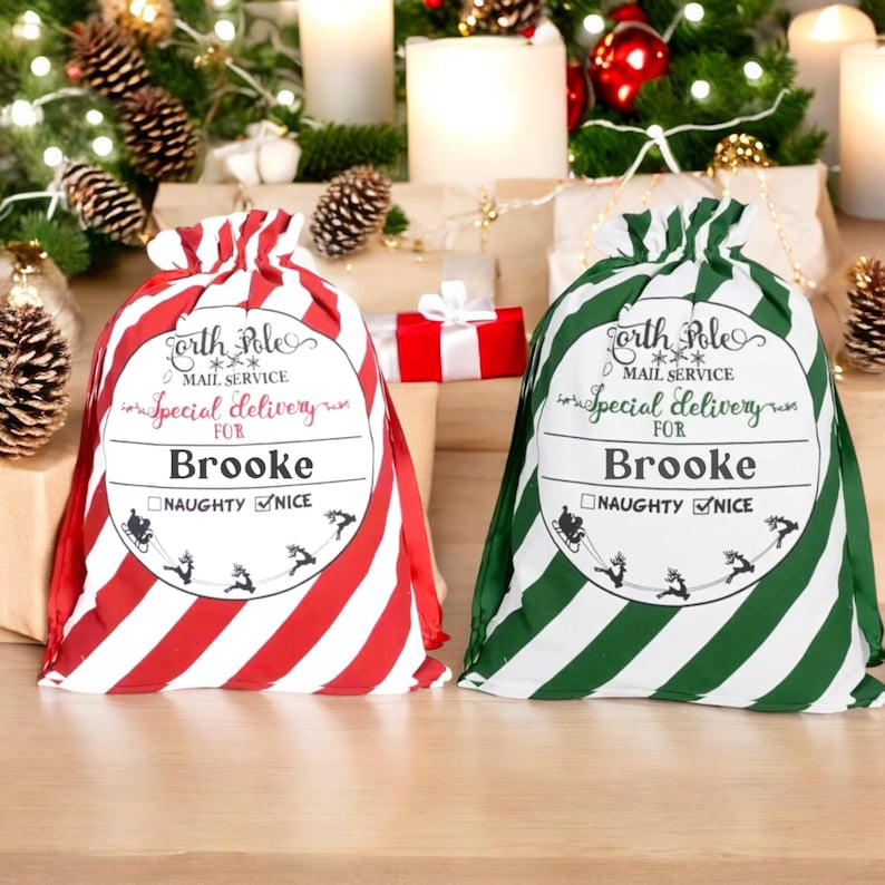 May include: Two red and green striped Christmas gift bags with white circles. The circles have black text that reads "North Pole Mail Service Special Delivery For Brooke Naughty Nice".  Each bag has a black and white illustration of Santa Claus in his sleigh.