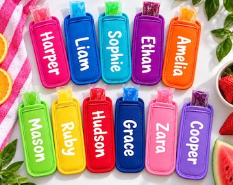 May include: A collection of twelve colourful neoprene ice pop sleeves, each featuring a white name printed vertically. The sleeves come in various bright colours including pink, blue, teal, purple, orange, lime green, yellow, red, and light pink.