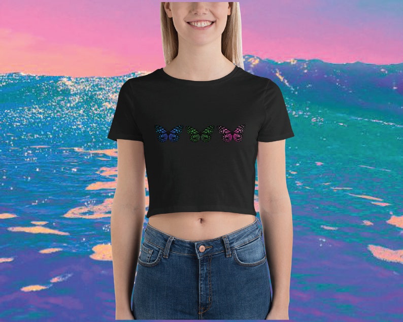 May include: A black cropped t-shirt with three colorful butterfly designs. The butterflies are in shades of blue, green, and pink.