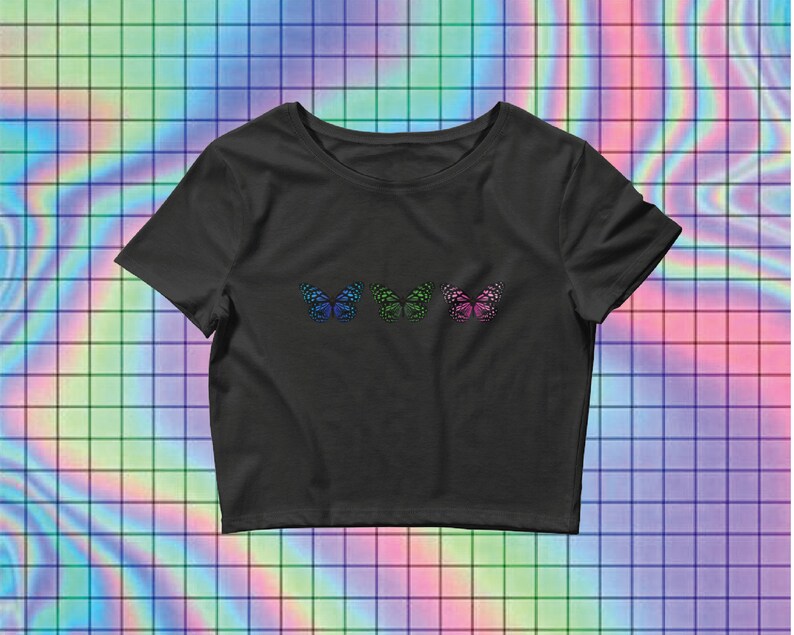 May include: Black cropped t-shirt with three colorful butterfly designs on the front.