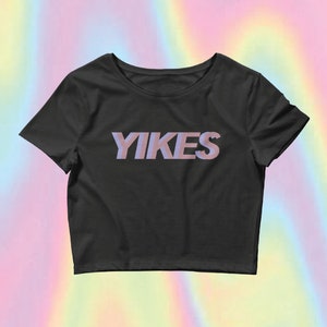 May include: A black cropped t-shirt with the word "YIKES" printed in pink on the front.