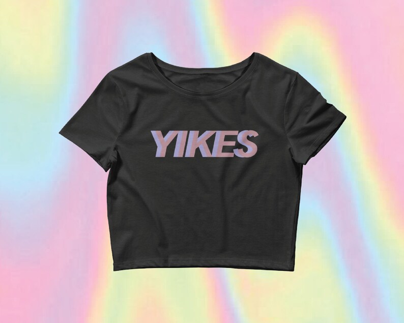 May include: A black cropped t-shirt with the word "YIKES" printed in pink on the front.