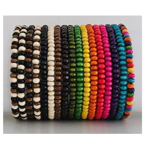 May include: A stack of colourful wooden bead bracelets in various shades of green, yellow, orange, red, purple, and blue. The bracelets are made of small, round beads.