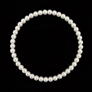 May include: A circular arrangement of white pearls against a black backdrop. The pearls are spherical and uniformly spaced, presenting a classic and elegant aesthetic. The image is well-lit, accentuating the pearls' lustre. A timeless piece of jewellery.