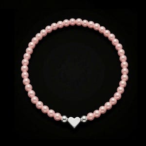 May include: A pink pearl bracelet with a silver heart charm. The bracelet is made of small, round, pink pearls, with a silver heart charm at the centre. Two silver beads are either side of the heart. The bracelet is set against a black background.
