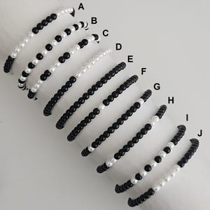 May include: A set of three ceramic mugs with a speckled, matte finish in cream, light grey, and dark grey. Each mug has a simple, minimalist design, suitable for coffee or tea.
