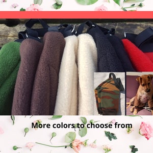 May include: A variety of fleece dog beds in different colors, including green, brown, white, black, and red. The beds have a strap for carrying.  More colors to choose from.