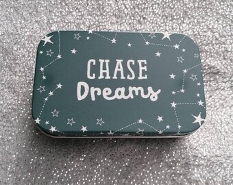 Metal 'chase dreams' tin.