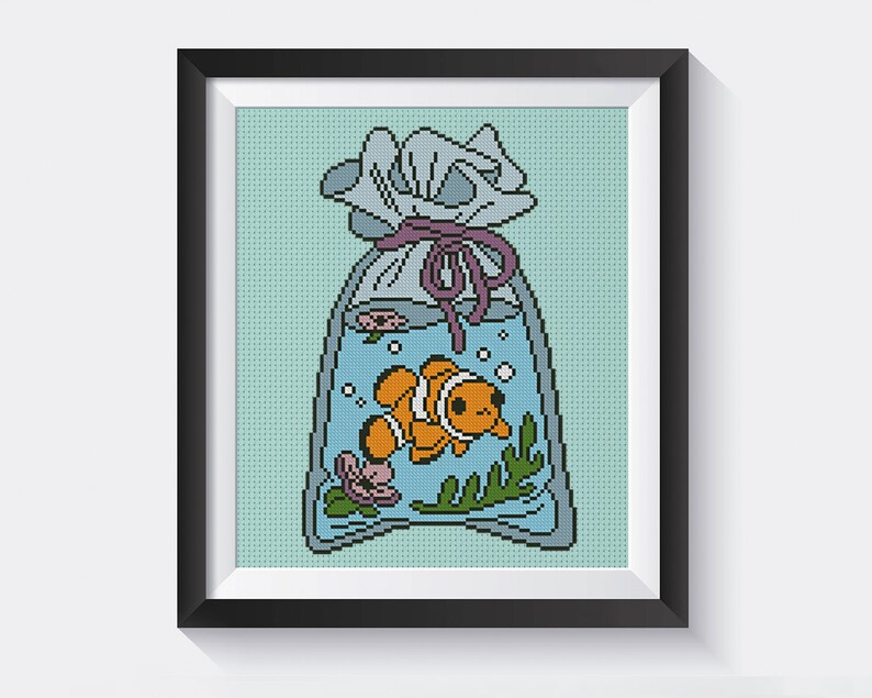 May include: A cross-stitch pattern of a cartoon clownfish swimming in a plastic bag tied with a purple ribbon. The bag is filled with blue water and has bubbles and seaweed inside.