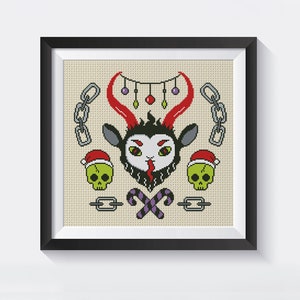 May include: A cross-stitch pattern featuring a cartoon goat with red horns and a black beard wearing a Santa hat. The goat is surrounded by candy canes, skulls, and chains.