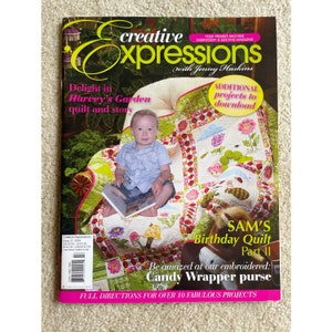 May include: A magazine cover featuring a quilt with a garden theme. The cover also includes a photo of a young child sitting in a chair and holding a book. The magazine title is "Creative Expressions" and the subtitle is "Delight in Harvey's Garden quilt and story".