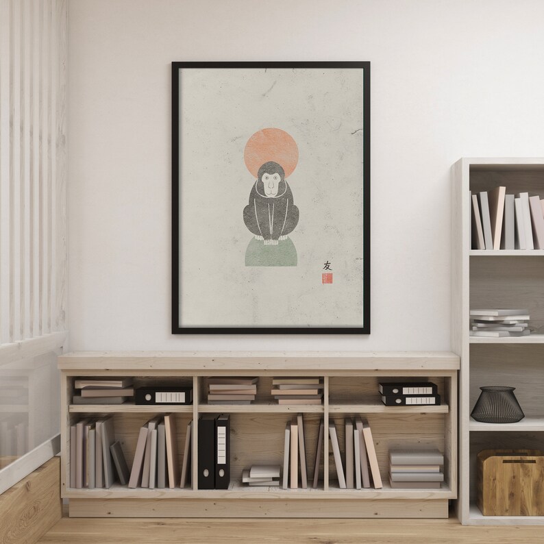 May include: A black and white illustration of a monkey sitting on a green rock with a red circle behind it. The image is framed in black and has the Japanese character for "friend" in red in the bottom right corner.