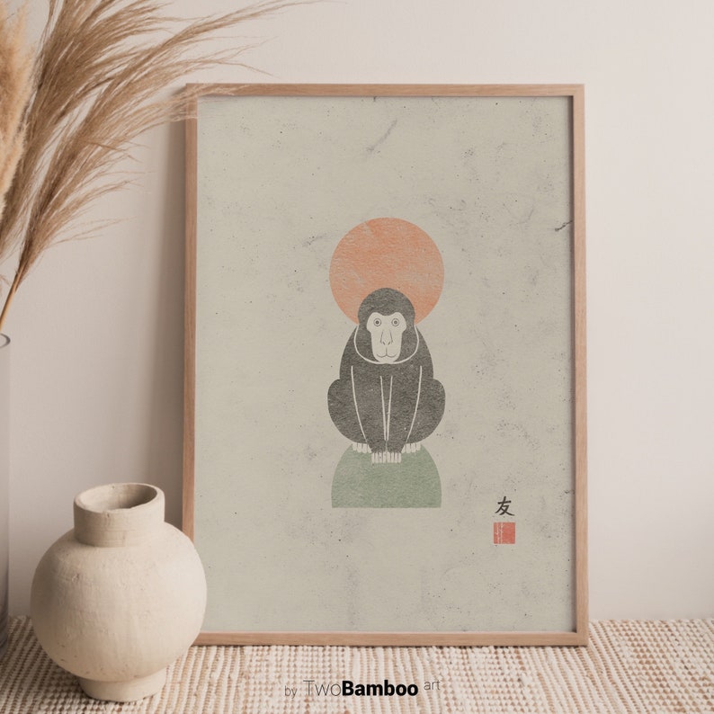 May include: A framed print of a black and white monkey sitting on a green circle with a peach colored circle above it. The print has a light green background and the Japanese character for "friend" in red.