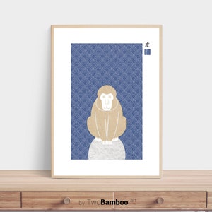 May include: A framed print of a brown monkey sitting on a white circle against a blue background with a white pattern. The Japanese character for "friend" is in the top right corner of the print.