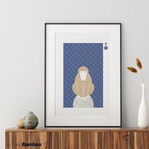 May include: A framed print of a brown monkey sitting on a rock against a blue background with a repeating pattern of white waves. The Japanese character for "friend" is in the top right corner of the print.