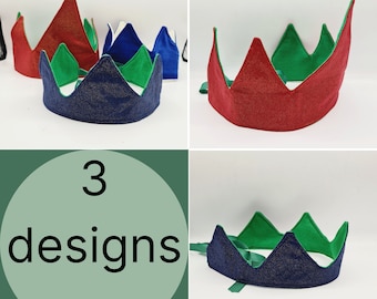 May include: Three felt crowns in different colors: red, blue, and navy blue. Each crown has a green felt trim and a sparkly finish. The crowns are displayed on a white background with the text "3 designs" in a circle.