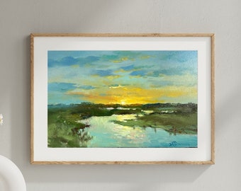 May include: A framed painting of a landscape with a river and a sunset. The sky is a light blue with clouds, and the sun is setting behind the river. The river is a light blue and green, and the land is a light green.