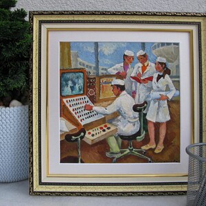 May include: A framed painting depicting a group of people in white lab coats working at a control panel. The panel has a large screen displaying a black and white image. The painting is set against a light blue background.