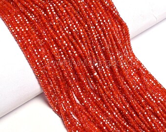 May include: Strands of faceted, vibrant orange beads. The beads are strung together, creating a flowing, textured appearance. The beads are small and uniform in size, reflecting light and adding a sparkling effect. The image is well-lit, highlighting the color and detail of the beads.