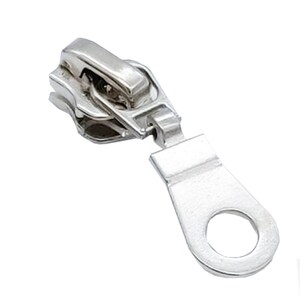 May include: Silver zipper pull with a loop on the end. The pull is designed to be used with a zipper on a garment or bag.