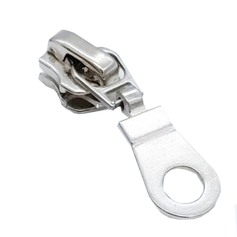 May include: Silver zipper pull with a loop on the end. The pull is designed to be used with a zipper on a garment or bag.