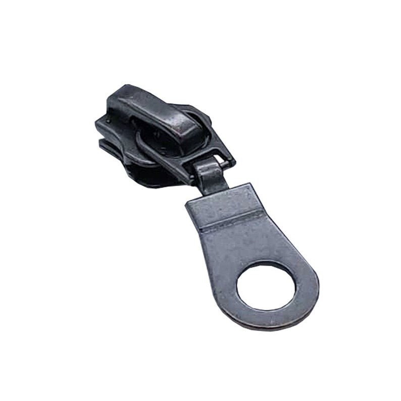 May include: A black metal zipper pull with a ring on the end. The pull is designed to be used with a zipper on a garment or bag.