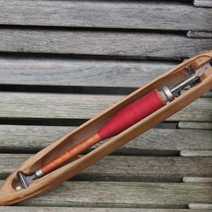 Antique weaving boat with spool of yarn, complete | Wooden loom shooter, industrial vintage | Classic loom boat.